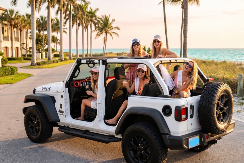 Group of friends laughing in a doors-off Jeep Willys on a Naples beach road